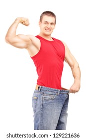 Weight Loss Man In An Old Pair Of Jeans Showing His Muscular Body Isolated On White Background