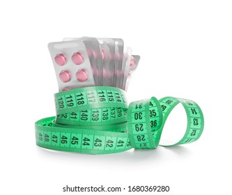 Weight Loss Pills With Measuring Tape On White Background