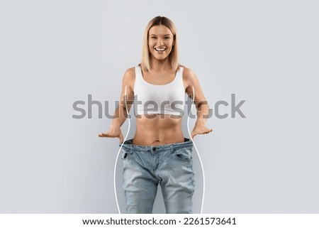 Weight loss, slimming, diets, detox, sport, fitness, healthy lifestyle concept. Emotional happy attractive slender middle aged blonde woman in big jeans over grey background, collage, copy space