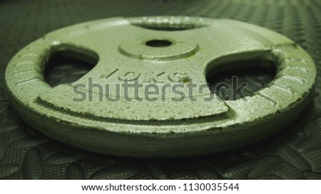 Weight plate for training is used in the gym.