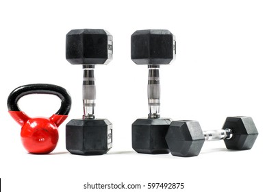 Weight Training Equipment. Big Red Kettlebell, Dumbells. Isolated On White.