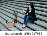 The Weight of Unemployment Middle-Aged Woman Engrossed in Reading. Stairway to Unemployment Sitting in Desolation