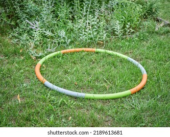 Weighted Hula Hoop On A Backyard Lawn In Summer Scenery, Core Workout Concept