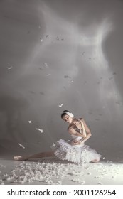 Weightlessness, Tender. Young Graceful Beautiful Woman, Balerina In Image Of White Swan With Feathers In Art Performance Isolated On White Background. Copy Space For Ad.