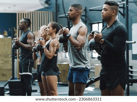 Weightlifting, fitness and people with kettlebell in gym for training, exercise and workout class. Teamwork, body builder and serious men and women lift weights for challenge, wellness and strength