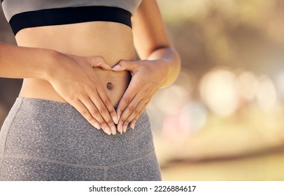 Weightloss, hands and heart shape on stomach for body positivity during diet, exercise and training. Wellness, health and closeup of woman with self love gesture on tummy while doing outdoor workout. - Powered by Shutterstock