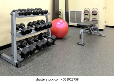 Weights, Fitness Ball, Medicine Balls, And Weight Bench In A Hotel Fitness Workout Room