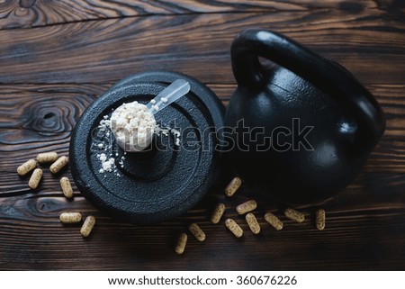 Weights and nutritional supplement, high angle view, close-up