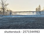 Weir on the Ostravice river and a traffic bridge in winter