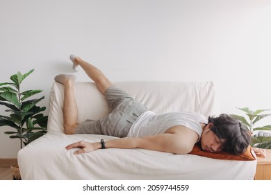 Weird and funny sleep pose of Asian man in his apartment in boring day off.