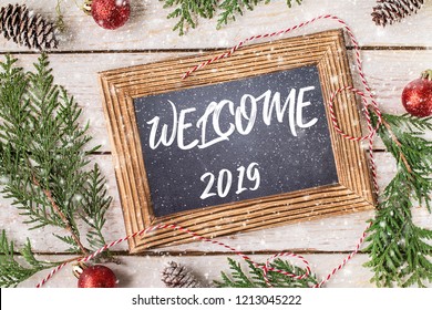 Welcome 2019. New Year Concept.  The Inscription 2019 On A Chalkboard. Winter Holidays Concept.  Top View. Space For Text