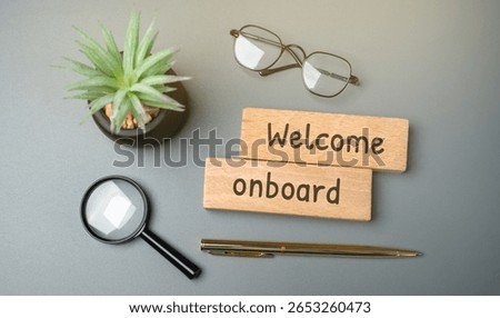 Welcome aboard concept. Friendly expression used to greet someone who is joining a team, company, group, or journey (like a trip or flight). It shows inclusion and a warm reception. Wooden blocks