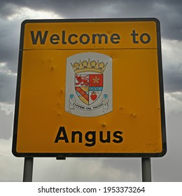 Welcome To Angus Sign At Local Authority Area Boundary. Scotland, UK. Authentic, Weathered Sign With Cloudy Background.