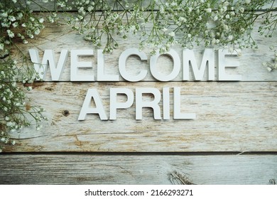 Welcome April Alphabet Letters With Flowers On Wooden Background