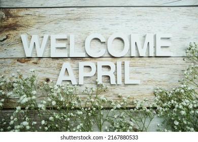 Welcome April Alphabet Letters With Flowers On Wooden Background