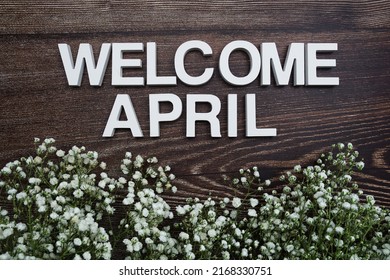 Welcome April Alphabet Letters With Flowers On Wooden Background