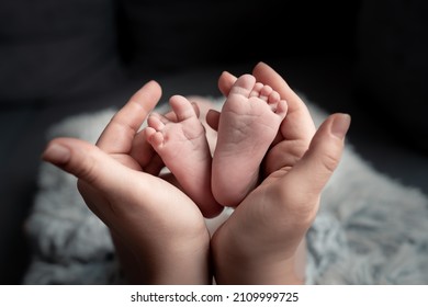  Welcome baby,Mother holding her newborn baby foot, love at first sight, baby feels love and security from mother, pro life - Shutterstock ID 2109999725