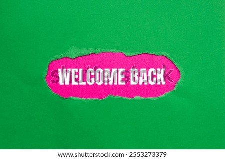 Welcome back message written on ripped torn green paper with pink background. Conceptual welcome back symbol. Copy space.
