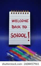 welcome back to school write between school supplies 