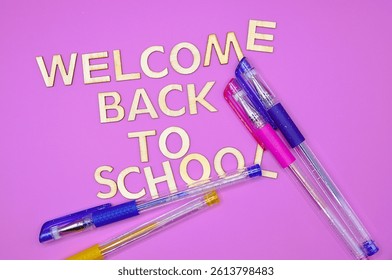 welcome back to school write between school supplies 