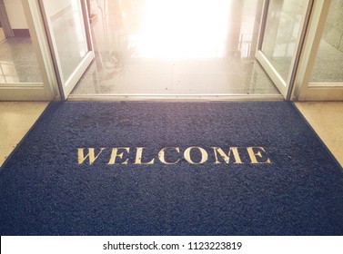 Welcome blue mat in front of door, shop - Shutterstock ID 1123223819