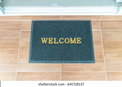 Welcome carpet at the front of the door.