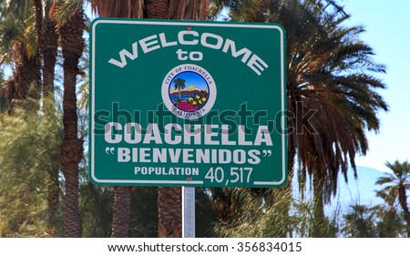 Welcome to Coachella, California road sign with palm trees backdrop