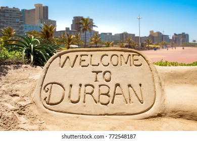 Welcome to Durban sand sculpture with skyline of Durban bay of plenty in the background