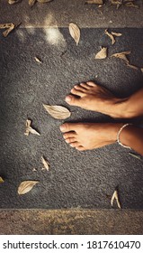 Welcome Fall Background. Closeup Concept Photo Of A Barefoot Women Feet And Dry Leaves. Autumn Season Theme. Summer Is Over.