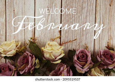 Welcome February typography text with rose flowers bouquet on wooden background