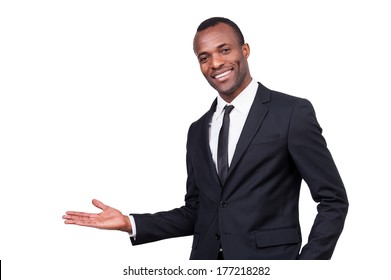 Welcome! Handsome Young African Man In Formalwear Gesturing And Smiling While Standing Isolated On White Background 