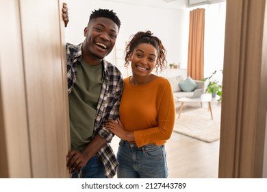 Welcome. Happy African American Couple Opening Door And Smiling To Camera Meeting Guests Standing At Home. Family Housing And Real Estate Ownership Concept. Selective Focus - Powered by Shutterstock