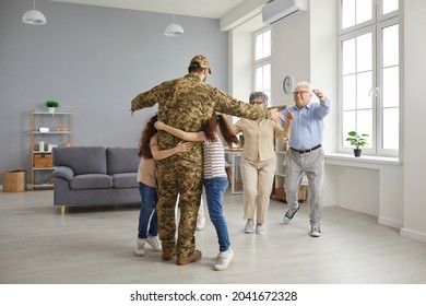 Welcome Home. Family Happy To See Veteran Soldier Who Has Come Back Home From The Military. Excited Little Children Hugging Their Daddy. Senior Mother And Father Running To Embrace Their Adult Son