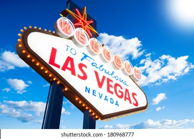 Welcome To Las Vegas neon sign on blue cloudy sky background