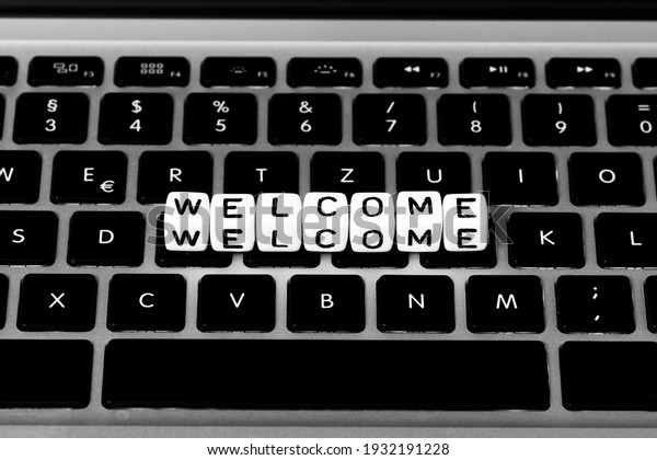 Welcome, Letter cubes on a\
keyboard