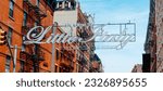 Welcome to Lttle Italy sign hanging on a street in New York City, United States, on a sunny spring day, in a panoramic format to use as web banner