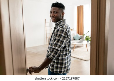 Welcome To My New House. Happy African American Guy Entering His Apartment Opening The Door And Smiling Looking At Camera Standing At Home. Real Estate Purchase Concept