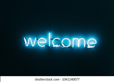 Welcome Neon Sign On Brick Wall Background