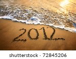 The welcome of the new year 2012 dramatic message in the sand at the beach near the ocean