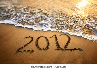 The welcome of the new year 2012 dramatic message in the sand at the beach near the ocean