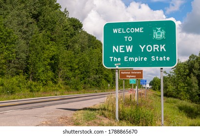 The Welcome To New York State Line Sign On US Route 62 In Chautauqua County, New York, USA On A Sunny Summer Day