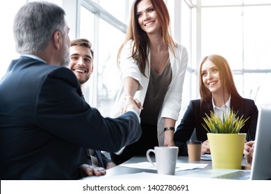 Welcome To Our Team! Business People Shaking Hands While Working In The Creative Office