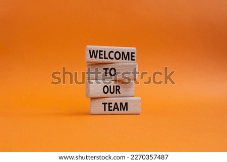 Welcome to our team symbol. Concept words Welcome to our team on wooden blocks. Beautiful orange background. Business and Welcome to our team concept. Copy space.