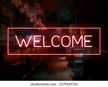A welcome sign in front of a bar or pub. Slightly blurred bar or tavern background. Nightlife concept. Red colors.