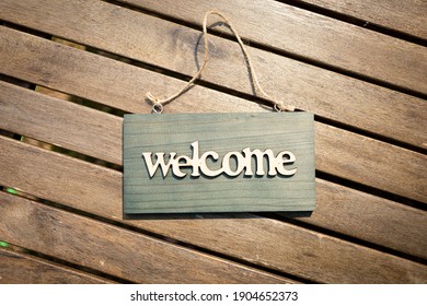 Welcome sign Invitation concept on wood texture background
