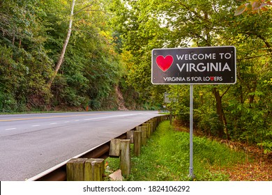Welcome to Virginia sign located at the Maryland, Virginia state border at Purcellville, Virginia. The black sign has a red heart shape and 'Virginia is for lovers' slogan underneath.