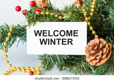 Welcome Winter Text Card Next To Spruce Branches With Cones And Decorations