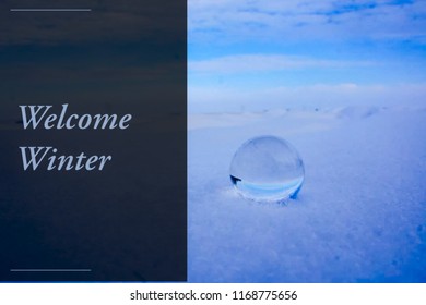 Welcome Winter Text On Blue Snow With Glass Gazing Ball