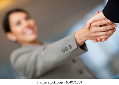Welcoming Business Woman Giving A Handshake And Smiling
