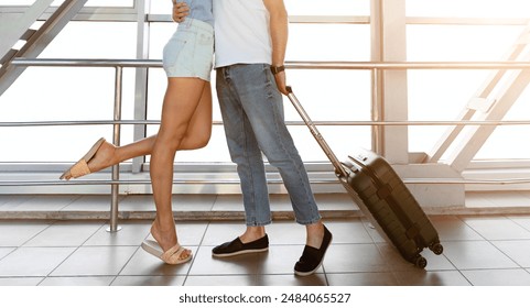 Welcoming embrace. Couple hugging tight after long separation, standing in airport, free space - Powered by Shutterstock